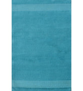 Solid teal hand-tufted wool rug with minimalist linear design